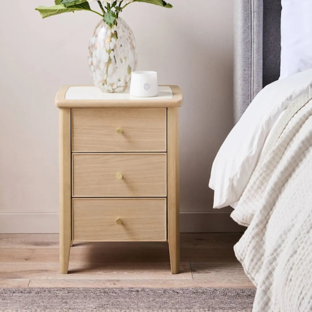 elegant wooden nightstand with marble top and gold knobs