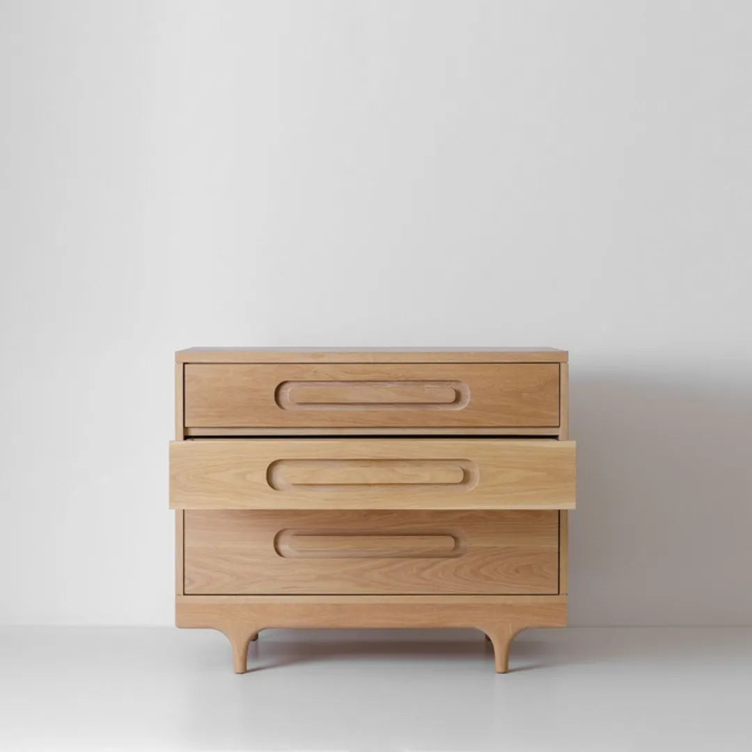 modern wooden chest of drawers with curved handles and elegant legs